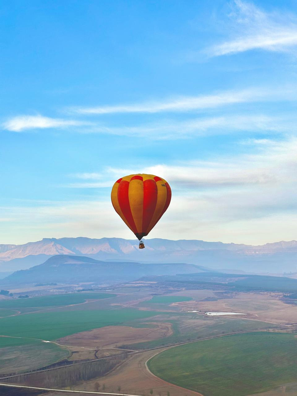 Passengers preparing for a shared sunrise hot air balloon flight in the Drakensberg valleys